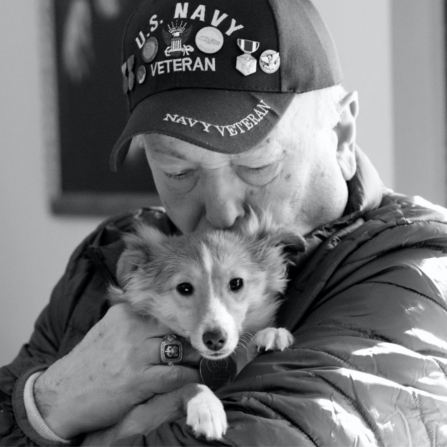 Veteran recient of Meals on Wheels with his dog. 