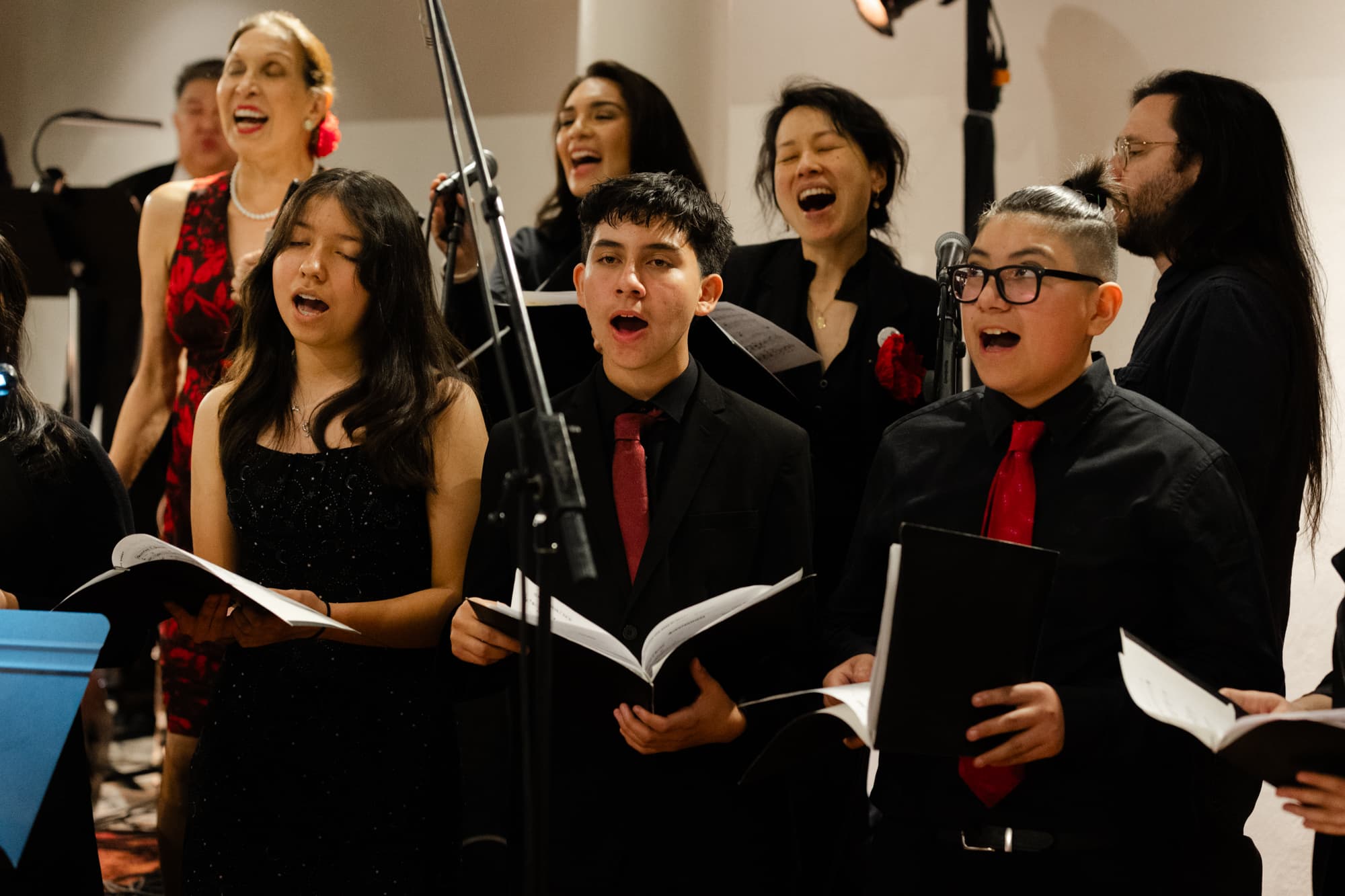Smiling woman giving a piggyback ride to a laughing young girl.