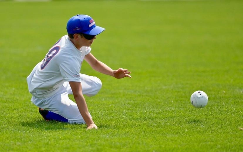 Matthew D. of the Strong dives for a ground ball