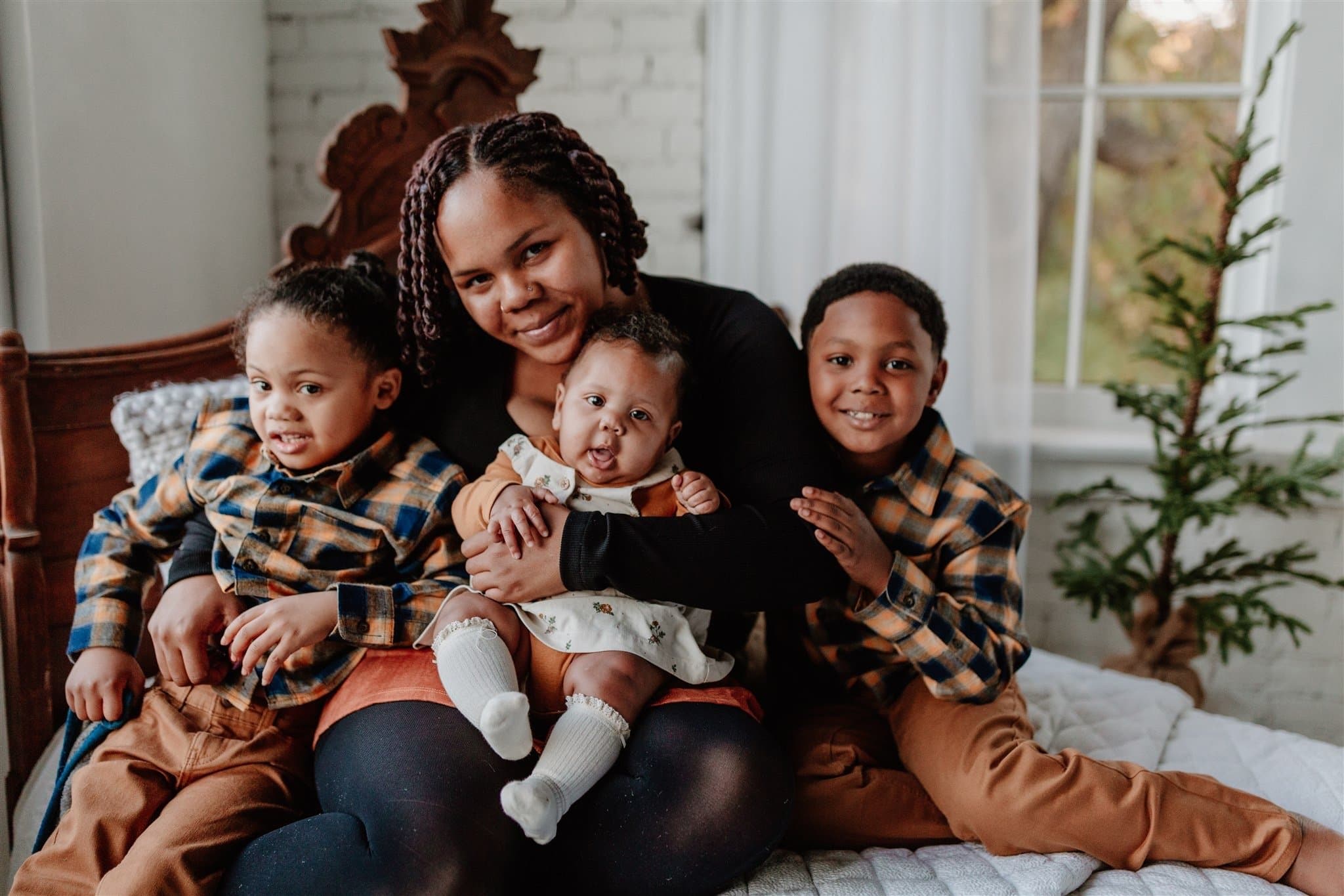 Adrianna, her daughter Brooklyn, and her two sons pose for a photo.