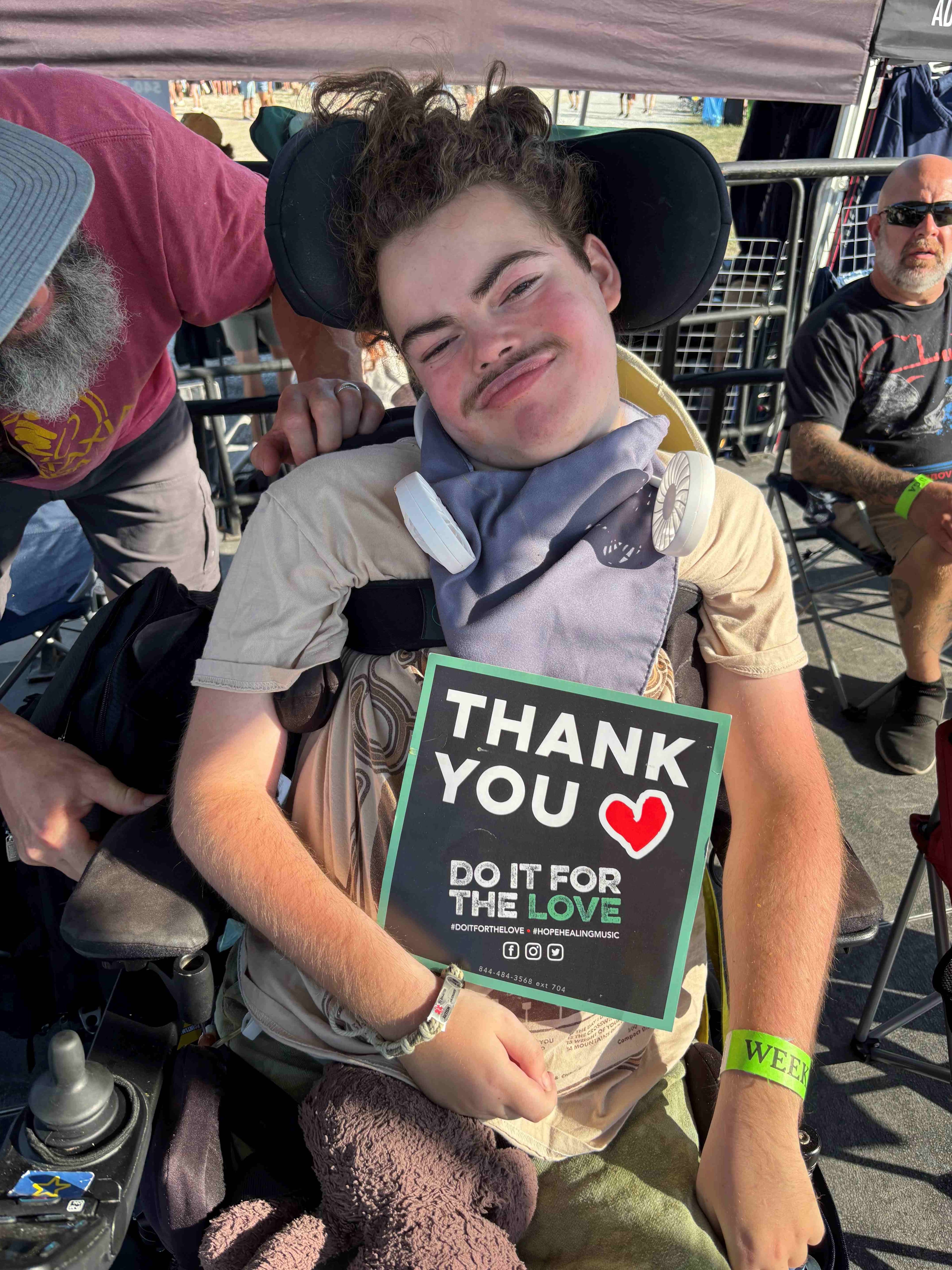 Logan holding the Thank you sign