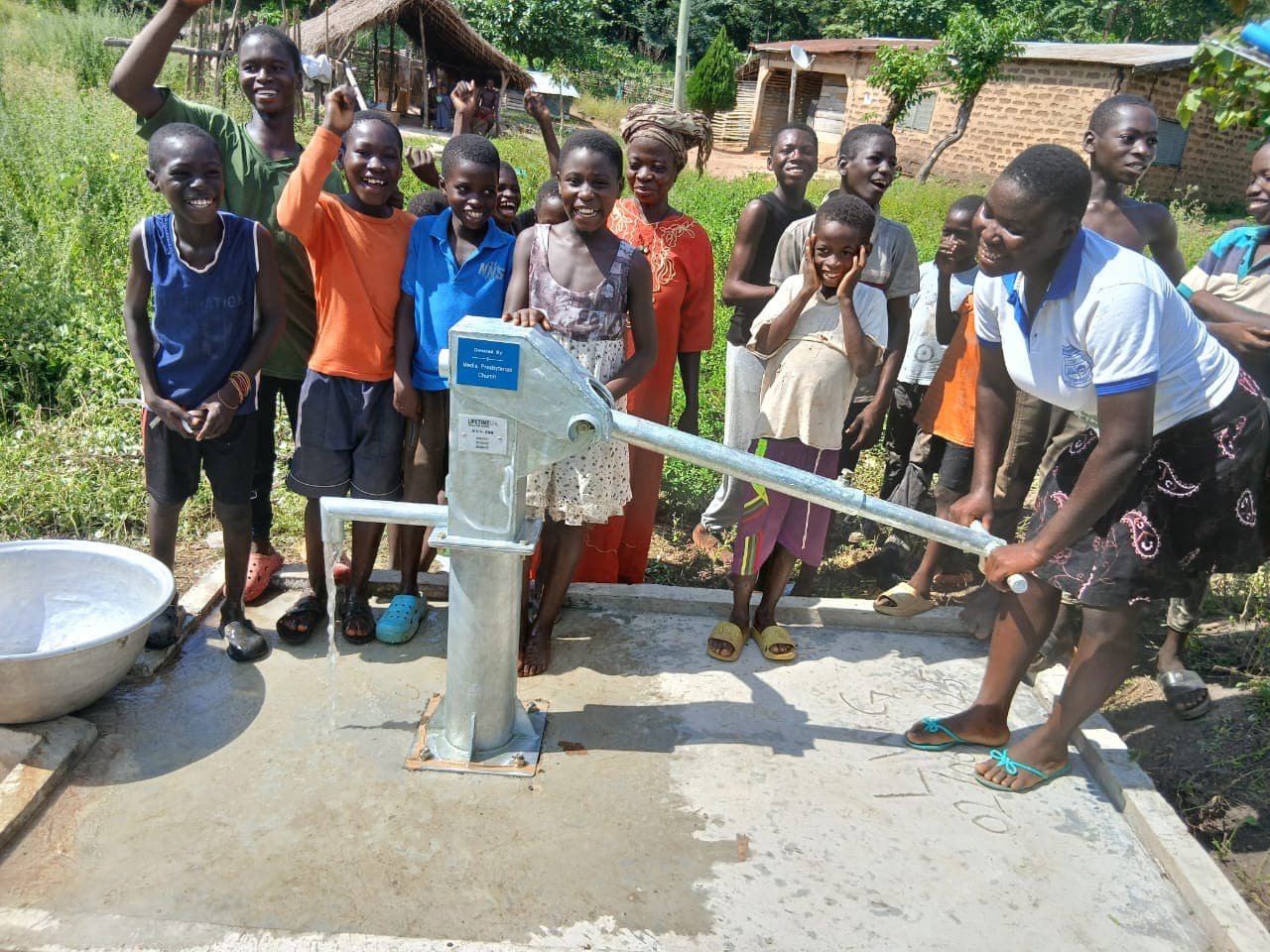 Smiling woman giving a piggyback ride to a laughing young girl.